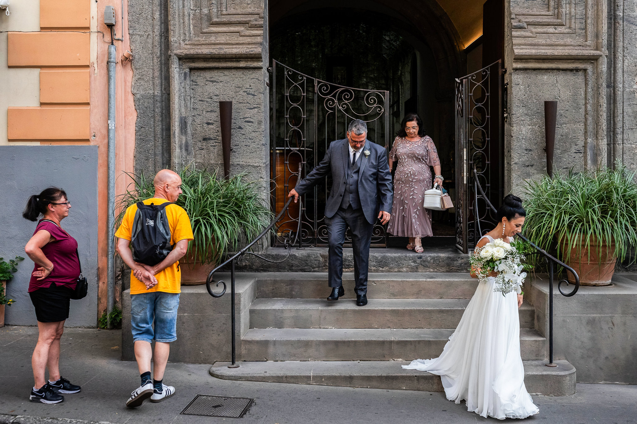 Palazzo Marziale exit with bride and her father and mother heading to ceremony