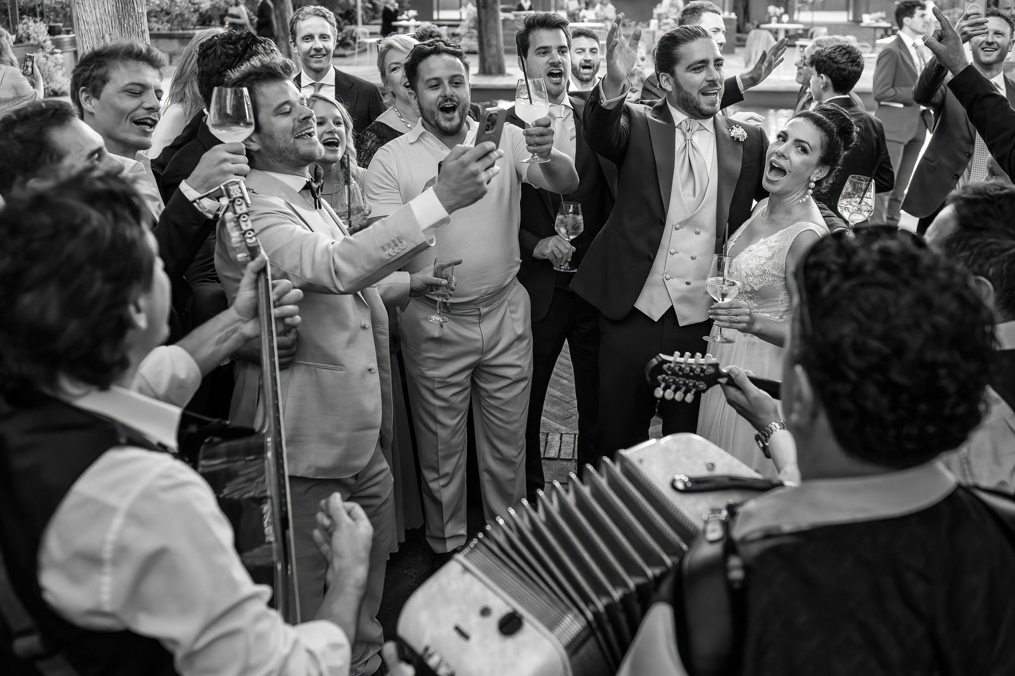 bride and groom with their guests singing and having fun