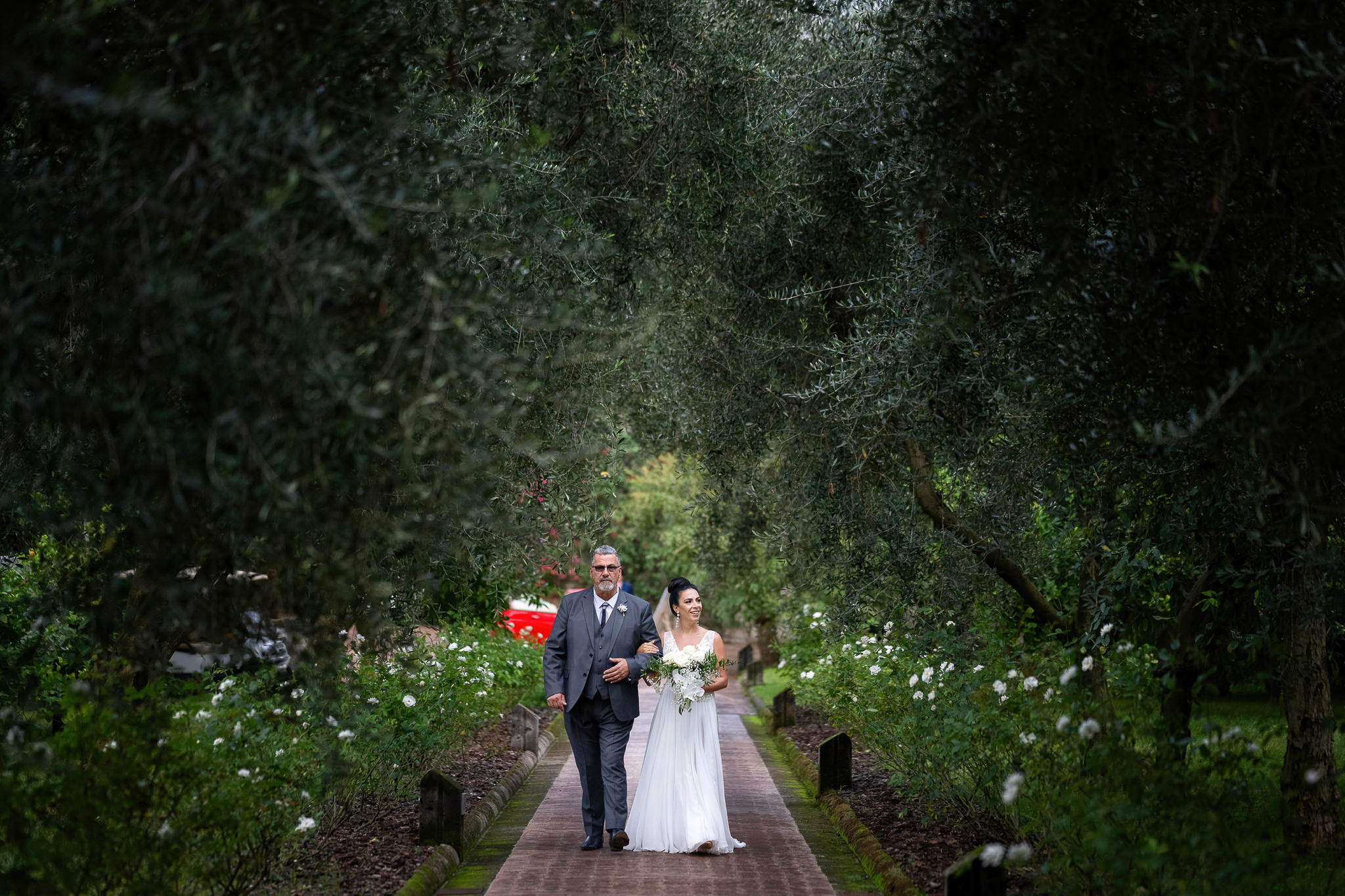 Bride and her father entering and walking the aisle of ceremony at Villa Zagara